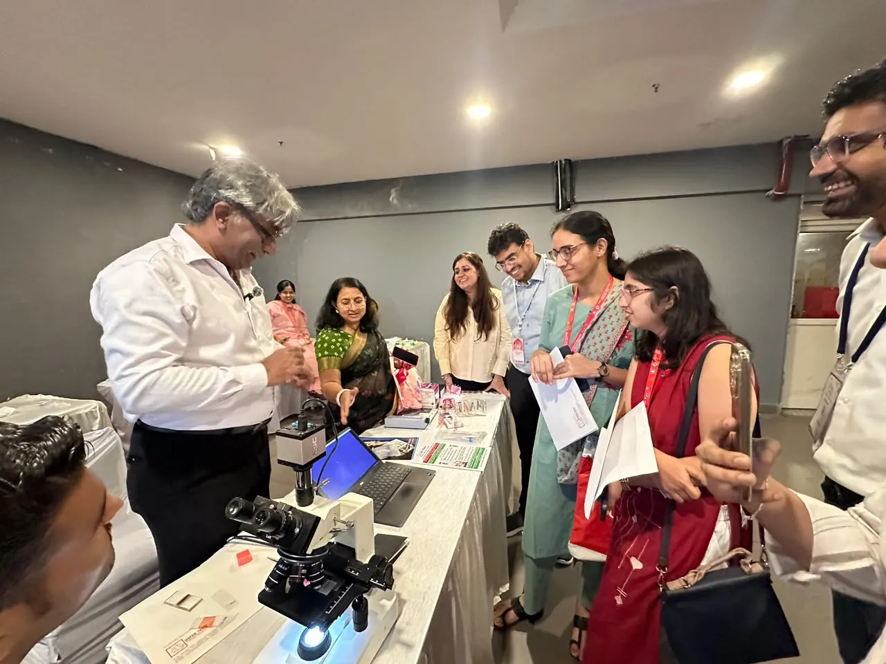 Rajnish Sehgal demonstrating in-depth semen analysis, with Dr. Sakshi Sehgal, at the Cell Mate station, FOGSI Jaipur 2026