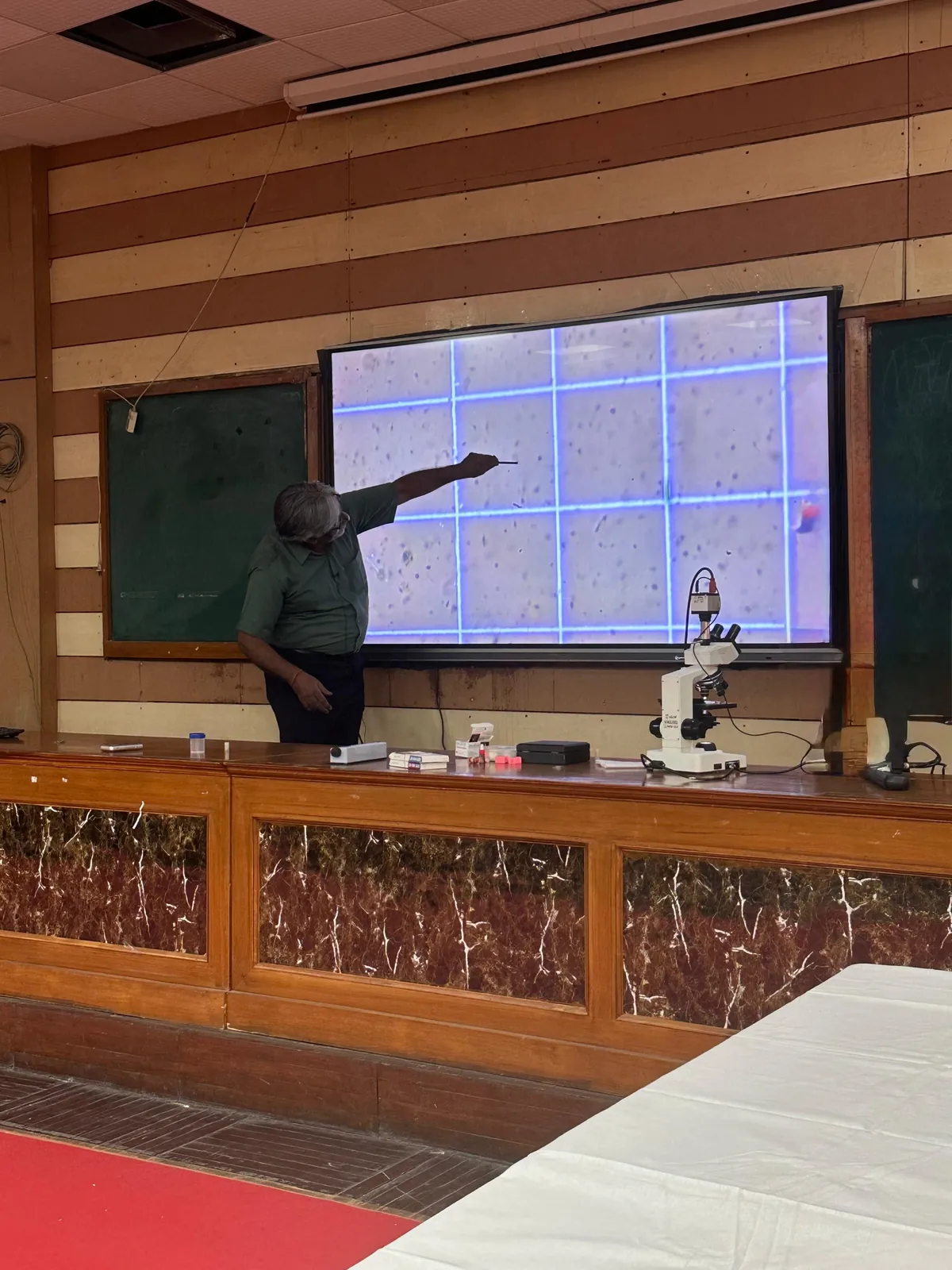 Rajnish Sehgal demonstrating live semen analysis under the microscope at the male infertility workshop